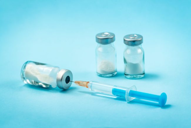 Syringe and needle with glass medical ampoule vials for injection Medicine is dry white drug penicillin powder or liquid with of aqueous solution in ampulla